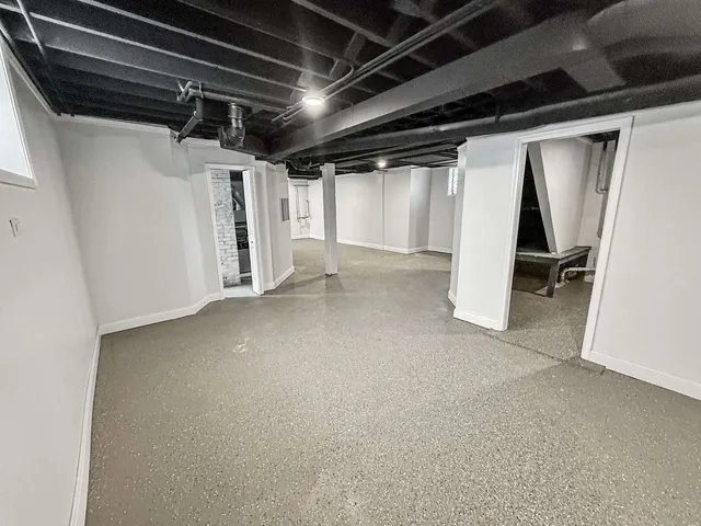 a view of empty room with wooden walls