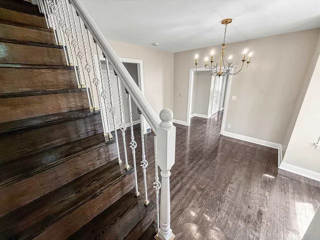 a view of entryway and hall with wooden floor