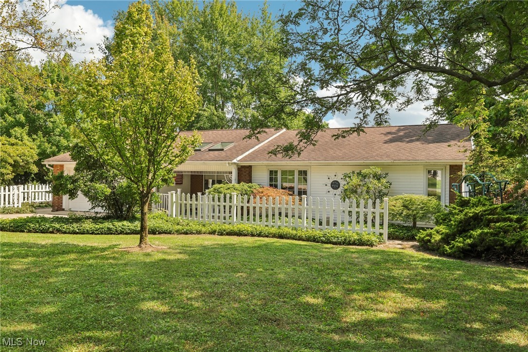 Rear view of house featuring a yard