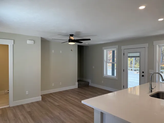 a bathroom with a granite countertop toilet and a sink