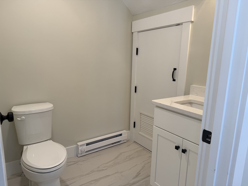 480 Wareham Street, Unit 12 Middleboro, MA 02346 - Photo 8 of 19 a bathroom with a granite countertop toilet and a sink