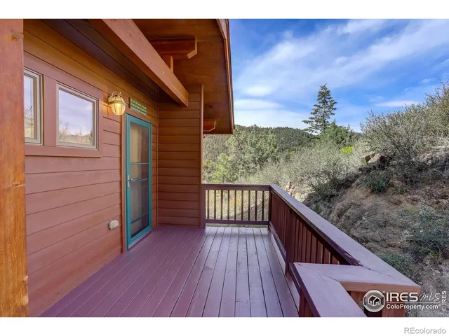a view of balcony with wooden floor and fence