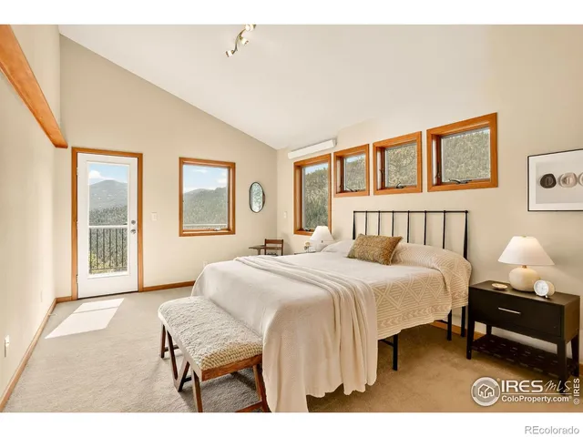 a bedroom with a bed a mirror and a window