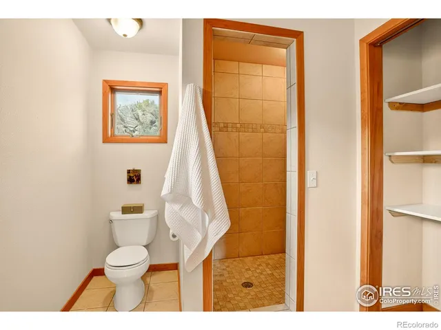 a living room with furniture a fireplace and a large window