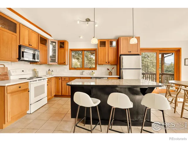 a open kitchen with stainless steel appliances kitchen island granite countertop a sink and cabinets