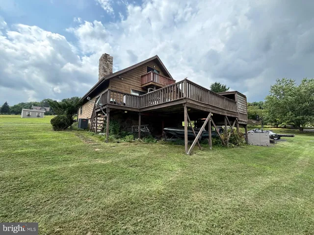 a view of a house with a yard and sitting area