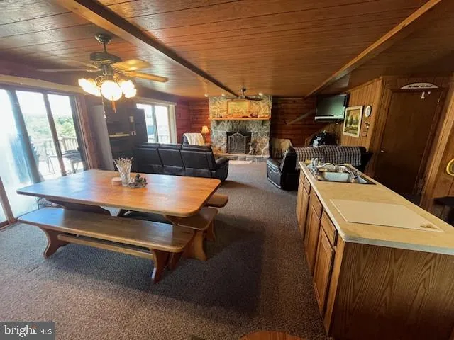 a room with furniture pool table flat screen tv and windows