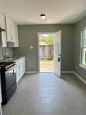a kitchen with a stove a sink and a refrigerator