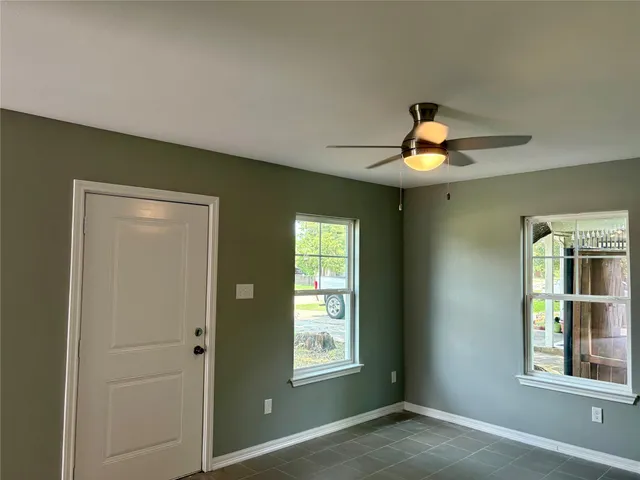 a view of a livingroom with a window and a chandelier