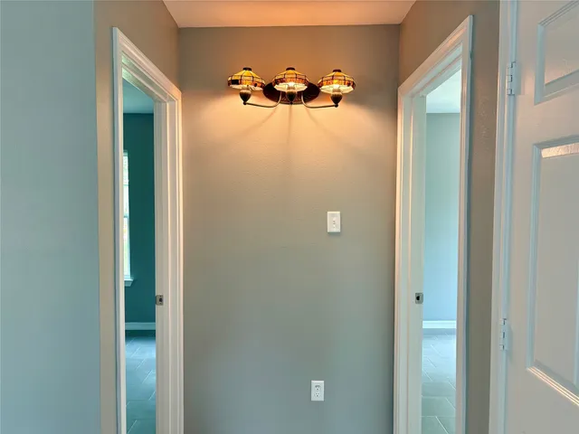 a view of a chandelier fan and closet area