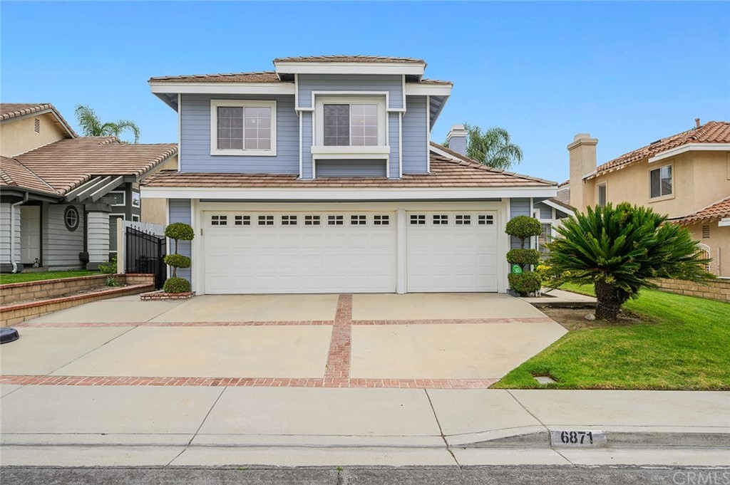 6871 Palermo Place Rancho Cucamonga, CA 91701 - Photo 1 of 1 a front view of a house with a yard and garage
