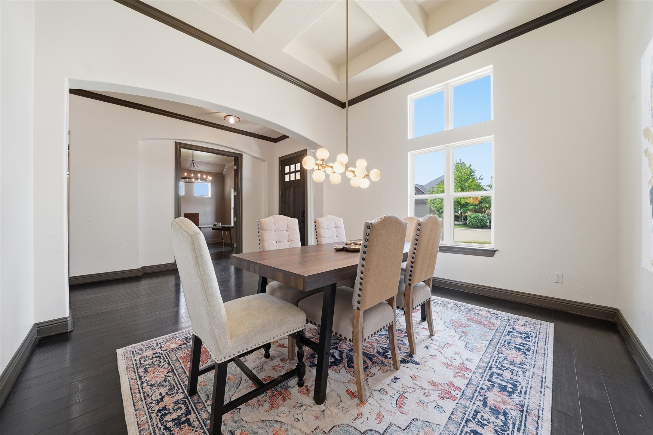 8729 Vantage Point Drive Austin, TX 78737 - Photo 5 of 33 A striking dining space features high ceilings and tall windows, creating an airy and well-lit atmosphere.