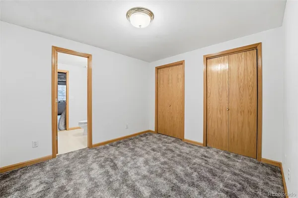 an empty room with closet area
