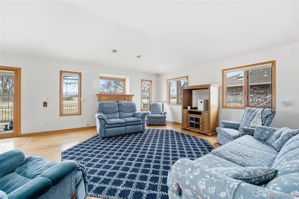 a living room with furniture fireplace and a window