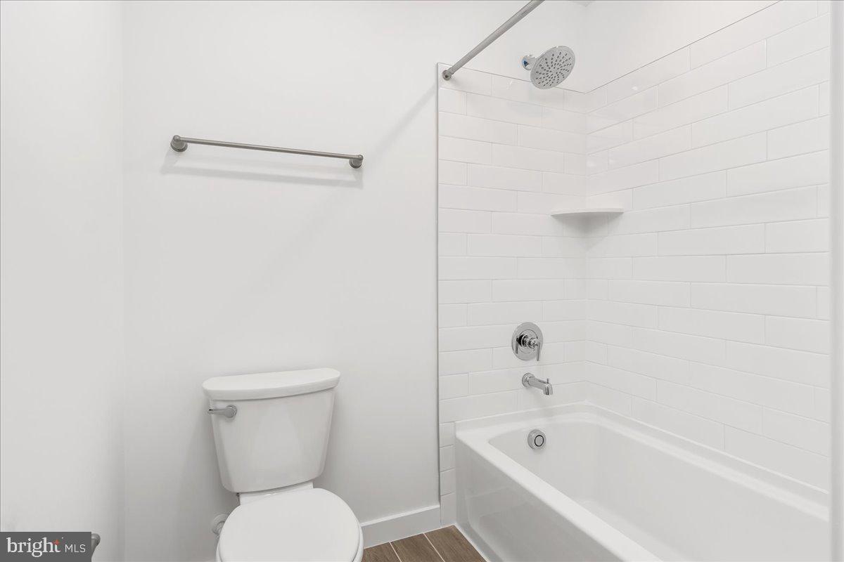 709 Iron Frg Road, Unit A Frederick, MD 21702 - Photo 14 of 15 a bathroom with a toilet and a bathtub