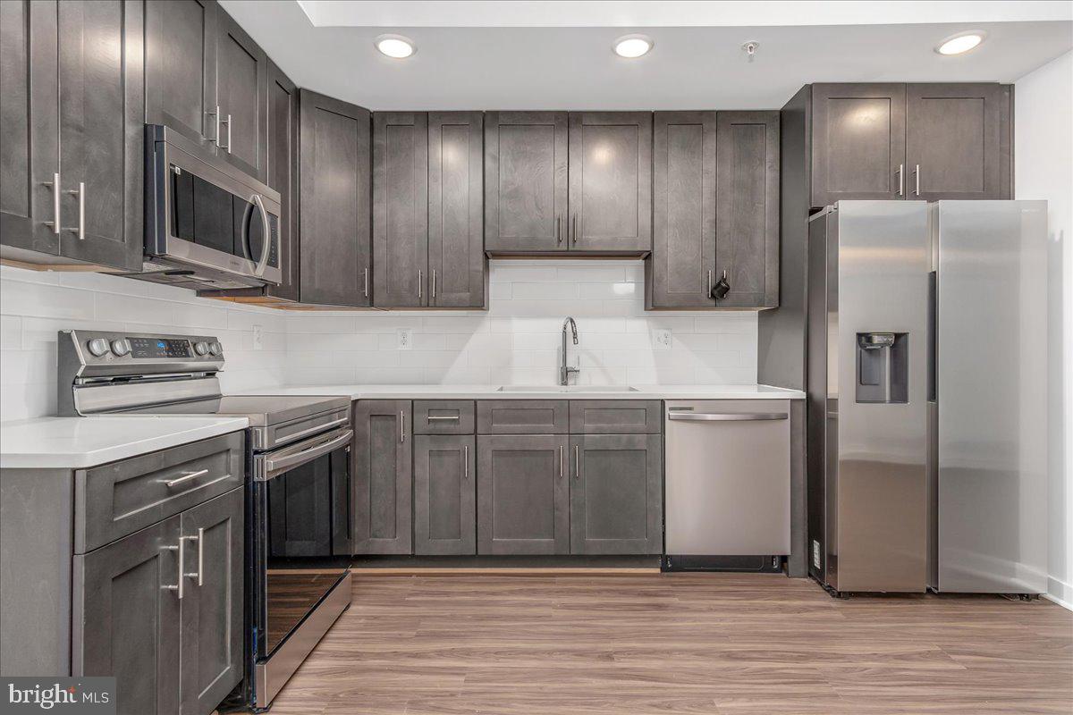 709 Iron Frg Road, Unit A Frederick, MD 21702 - Photo 6 of 15 a kitchen with a sink stainless steel appliances and cabinets