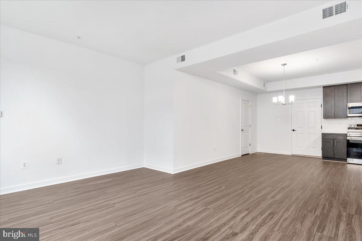 709 Iron Frg Road, Unit A Frederick, MD 21702 - Photo 7 of 15 a view of empty room with wooden floor