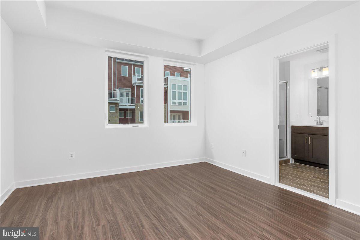 709 Iron Frg Road, Unit A Frederick, MD 21702 - Photo 9 of 15 a view of an empty room with wooden floor and a window