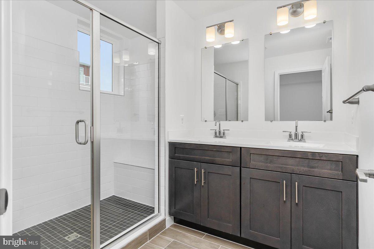 709 Iron Frg Road, Unit A Frederick, MD 21702 - Photo 10 of 15 a bathroom with a shower sink and mirror
