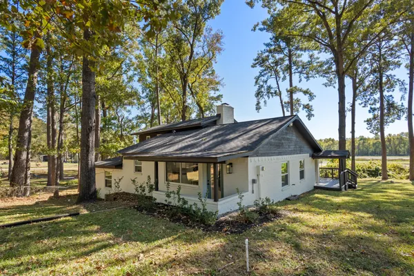 a view of a house with a yard balcony and tree
