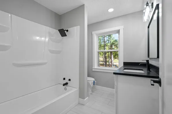 a bathroom with a bathtub and a window