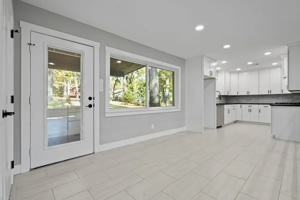 a view of an empty room with a kitchen