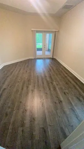 a white bath tub sitting in a bathroom next to a window