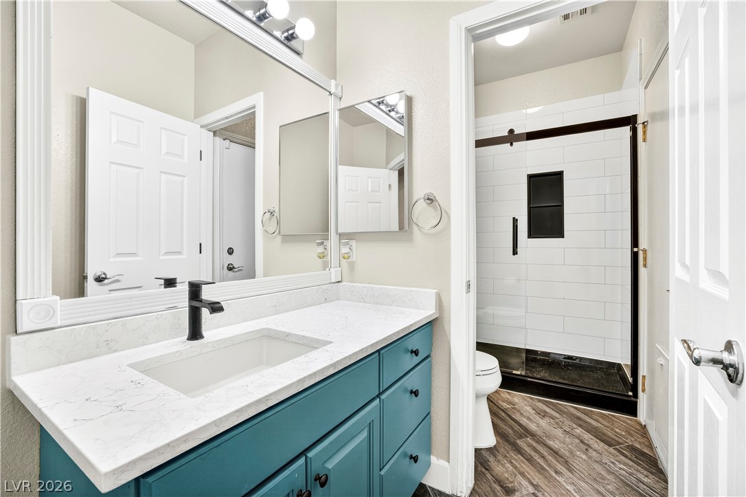 1135 Calico Ridge Drive Henderson, NV 89011 - Photo 24 of 86 A striking teal vanity with a pristine white countertop offers abundant storage within this refreshed bath.