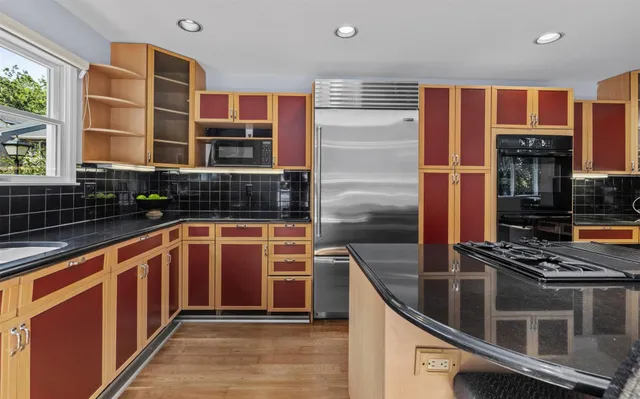 a kitchen with stainless steel appliances a stove and a sink