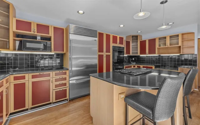 a kitchen with stainless steel appliances granite countertop a stove and a sink