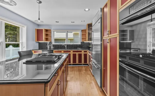 a kitchen with stainless steel appliances granite countertop a stove and a sink