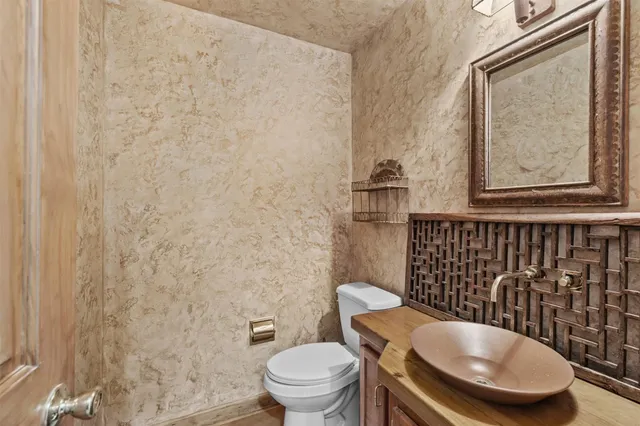 a bathroom with a toilet and a mirror