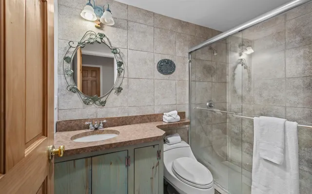 a bathroom with a sink toilet and shower