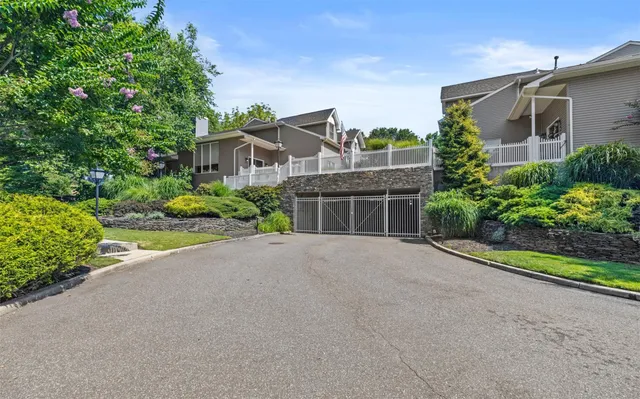 a front view of a house with a yard and a garage