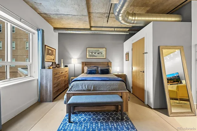 a bedroom with a bed and a mirror