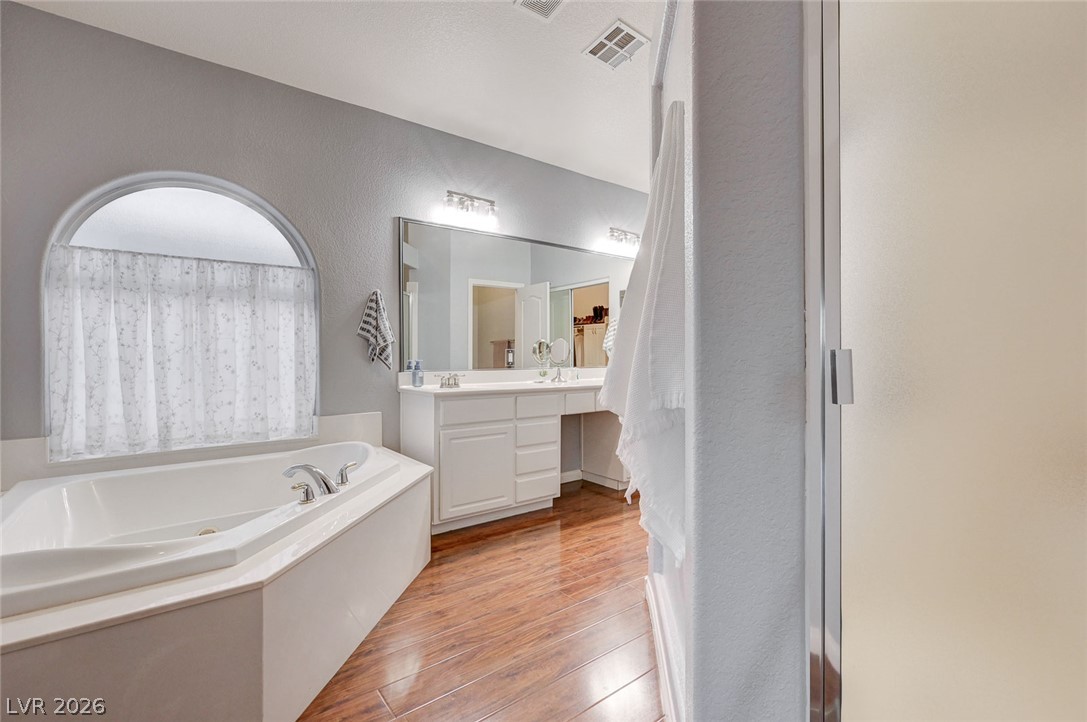 1604 Cattle Ranch Place Henderson, NV 89002 - Photo 38 of 99 Luxurious soaking tub and dual vanity set the stage for a serene daily routine.
