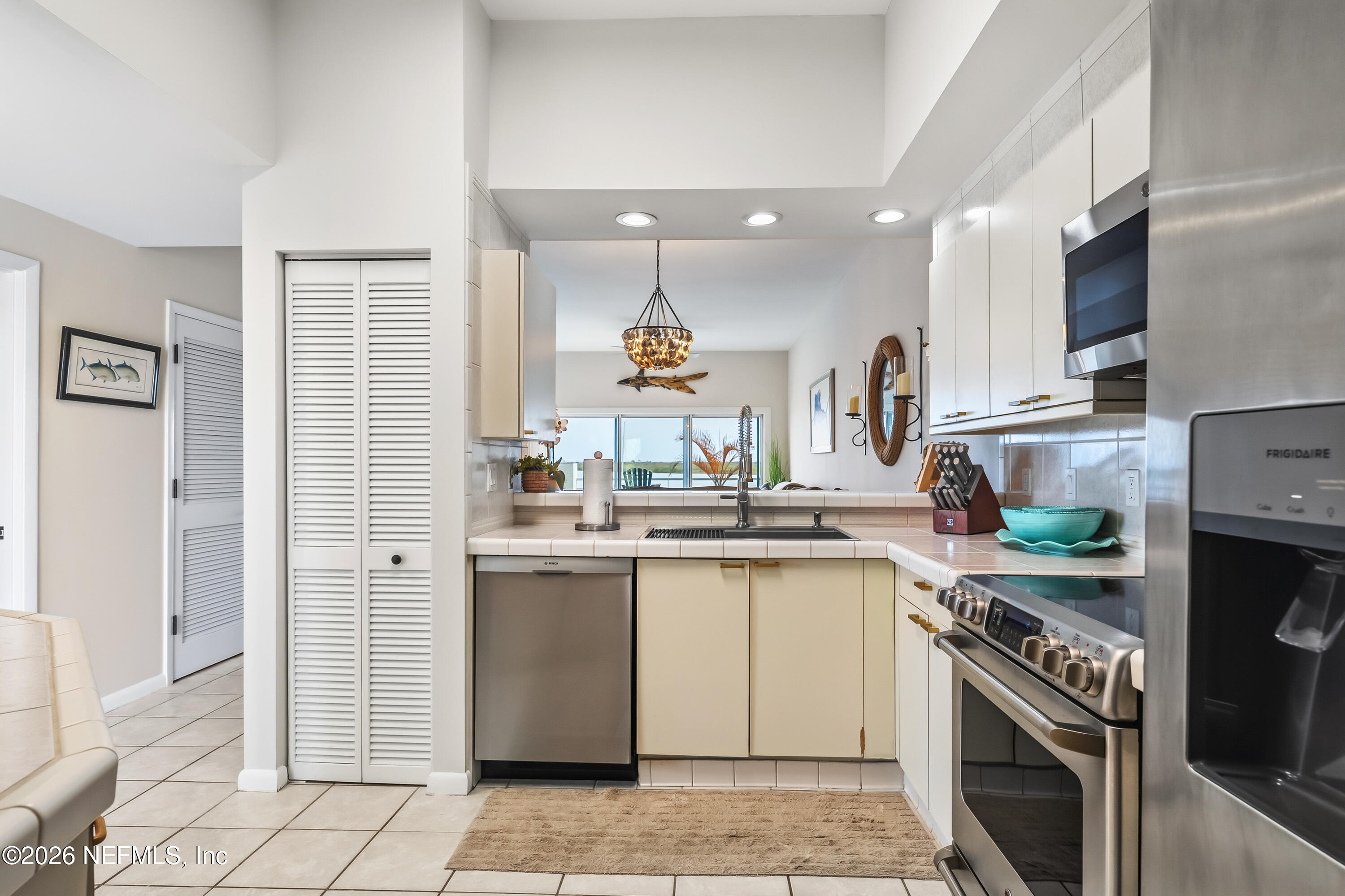 75 Comares Avenue, Unit 3A St. Augustine, FL 32080 - Photo 11 of 41 a kitchen with a sink stove and refrigerator