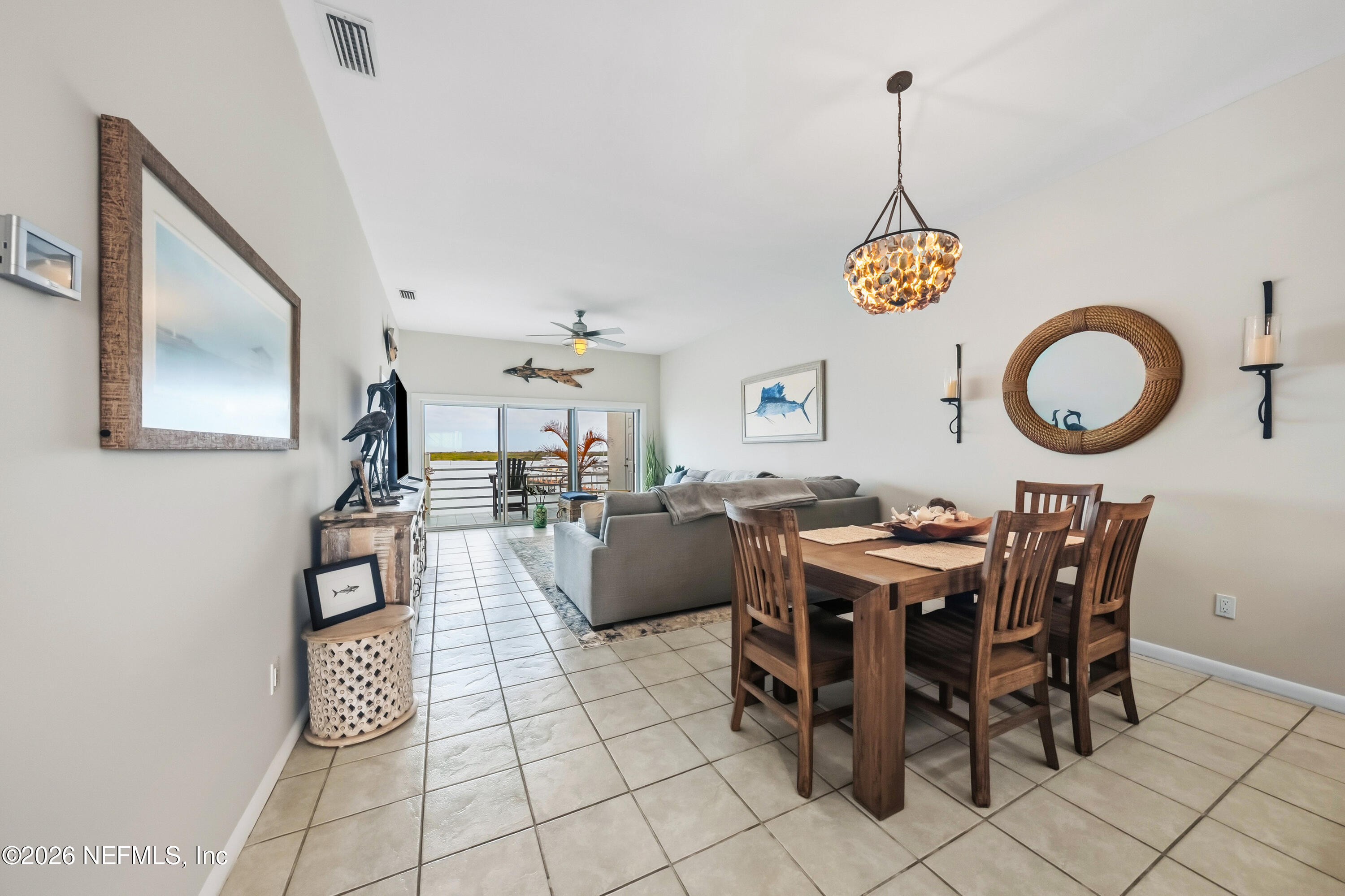 75 Comares Avenue, Unit 3A St. Augustine, FL 32080 - Photo 13 of 41 a view of a dining room and livingroom furniture and chandelier