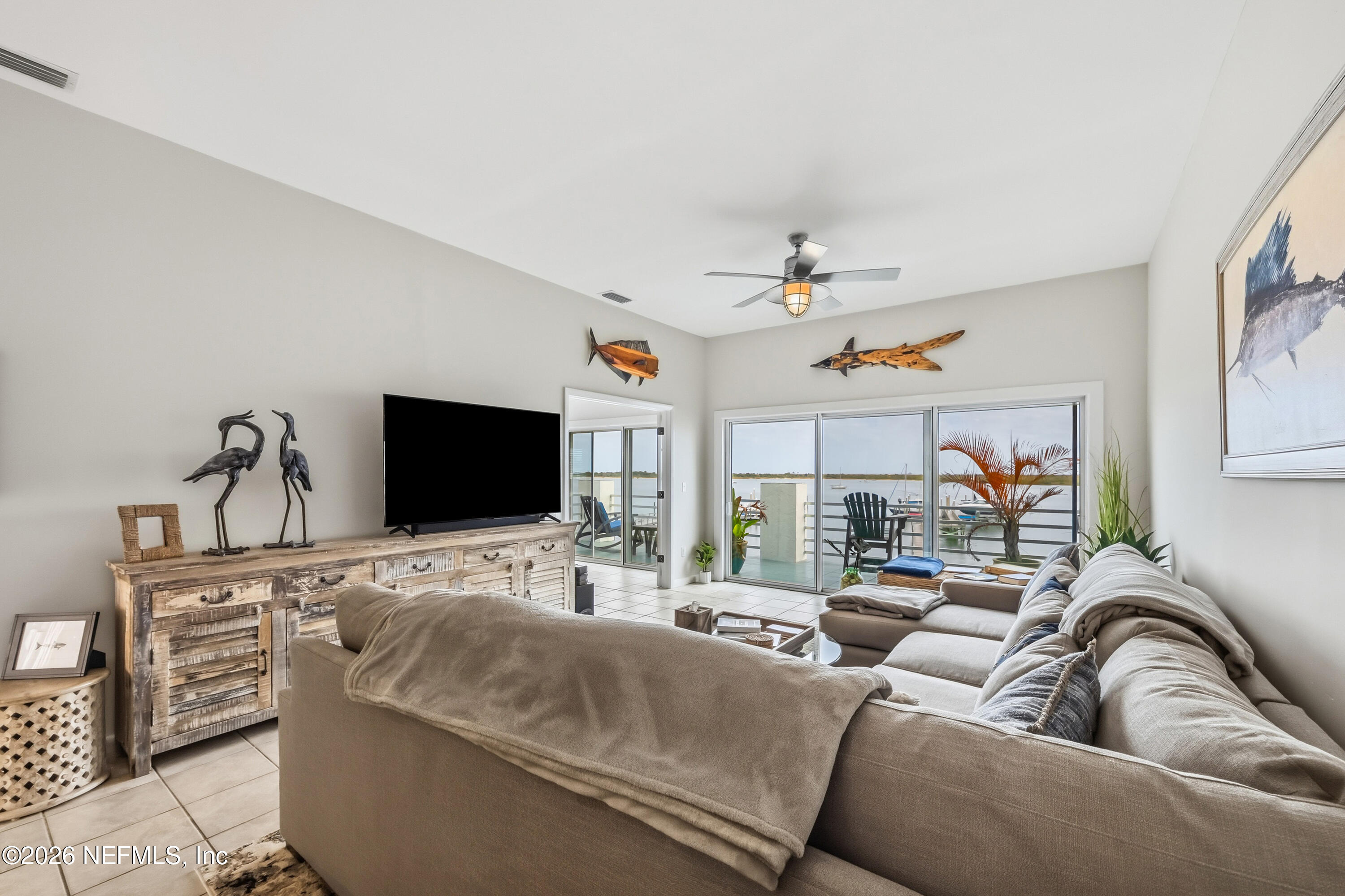 75 Comares Avenue, Unit 3A St. Augustine, FL 32080 - Photo 15 of 41 a living room with furniture and a flat screen tv