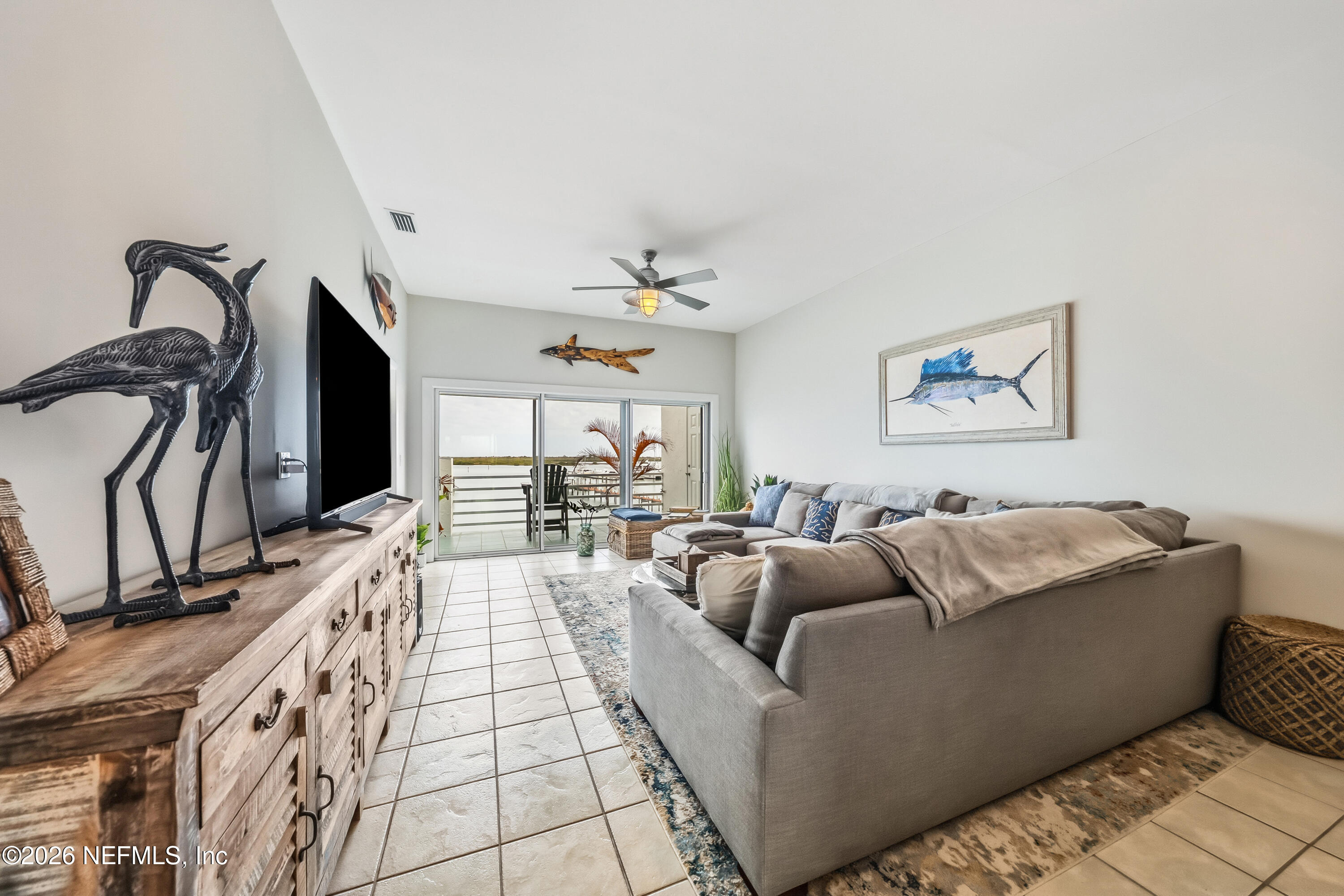 75 Comares Avenue, Unit 3A St. Augustine, FL 32080 - Photo 16 of 41 a living room with furniture and a flat screen tv