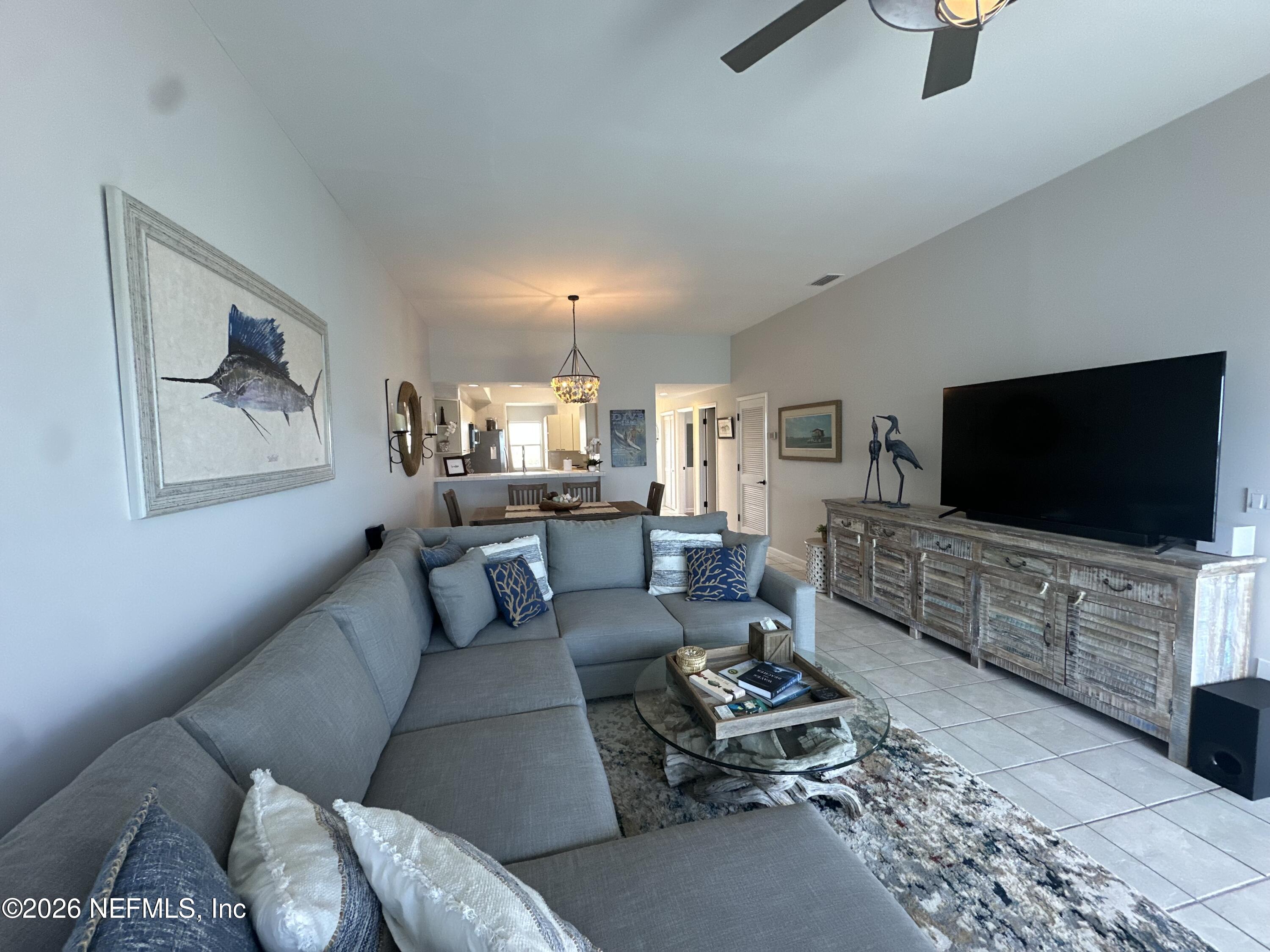 75 Comares Avenue, Unit 3A St. Augustine, FL 32080 - Photo 17 of 41 a living room with furniture and a flat screen tv