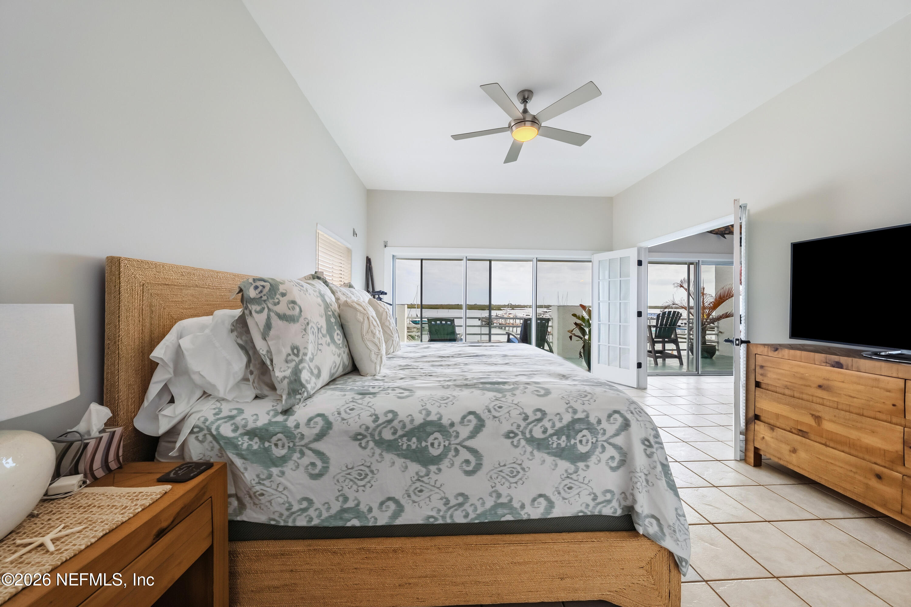 75 Comares Avenue, Unit 3A St. Augustine, FL 32080 - Photo 19 of 41 a bedroom with a bed and flat screen tv