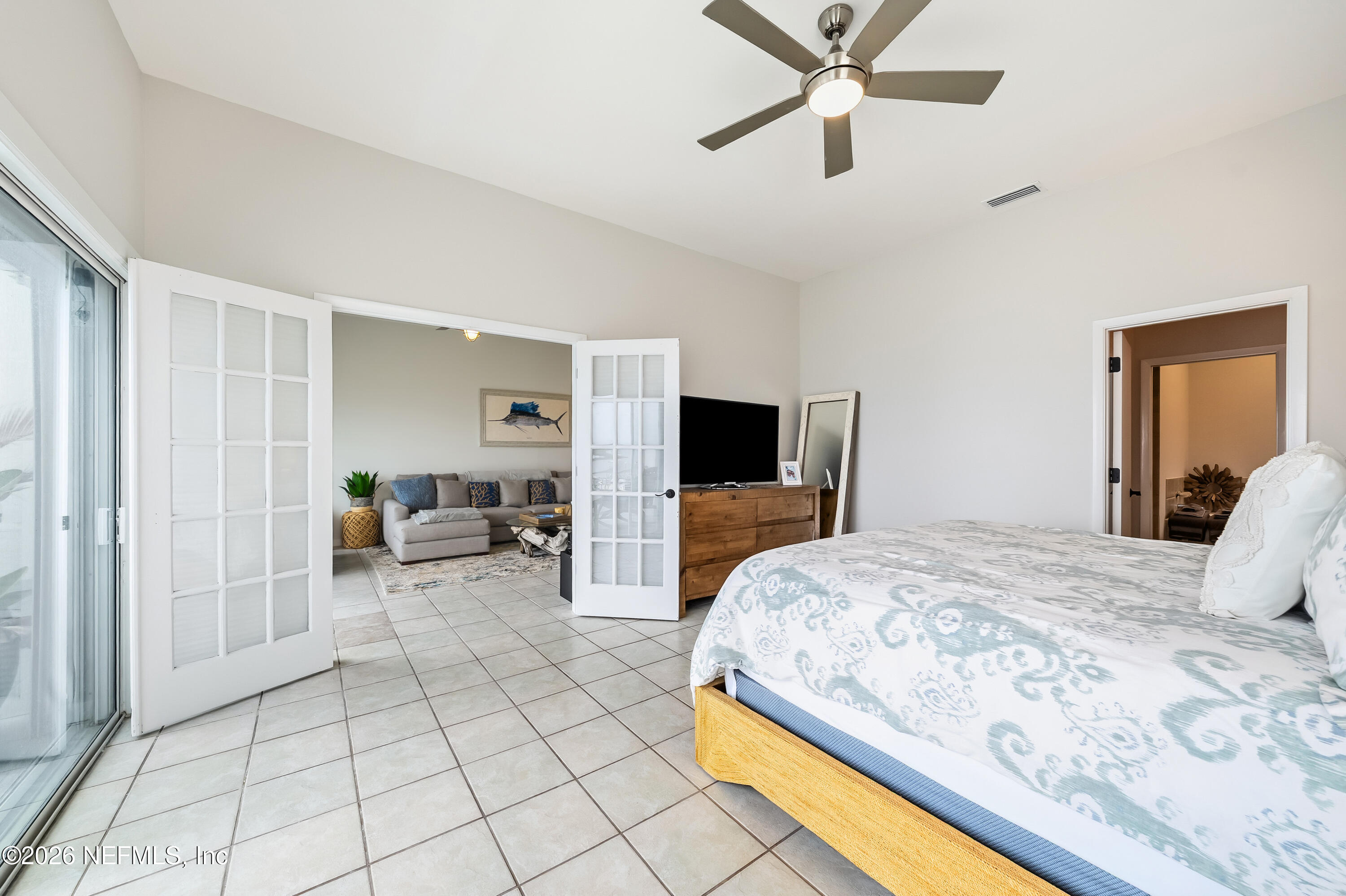 75 Comares Avenue, Unit 3A St. Augustine, FL 32080 - Photo 20 of 41 a bedroom with a bed and a television