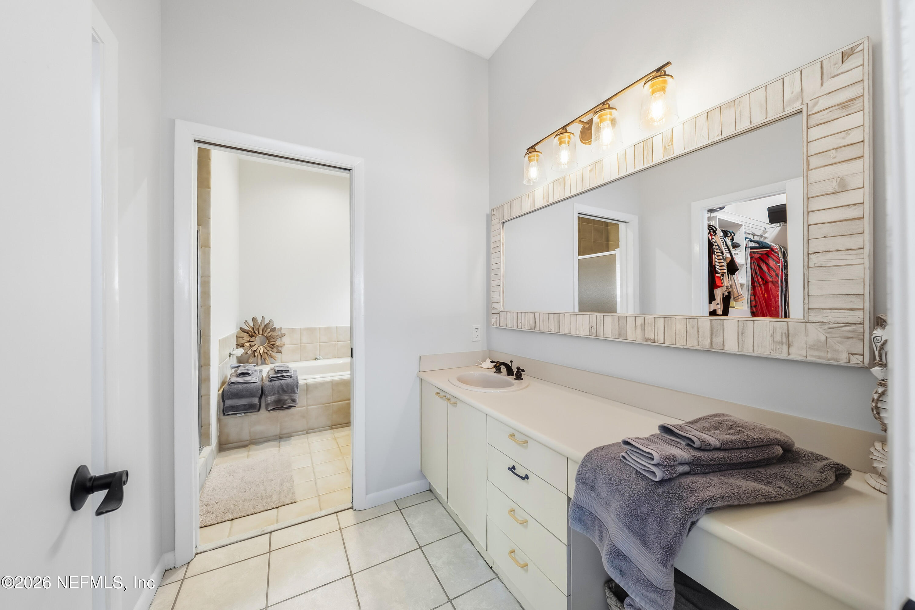 75 Comares Avenue, Unit 3A St. Augustine, FL 32080 - Photo 21 of 41 a bathroom with a tub sink and mirror