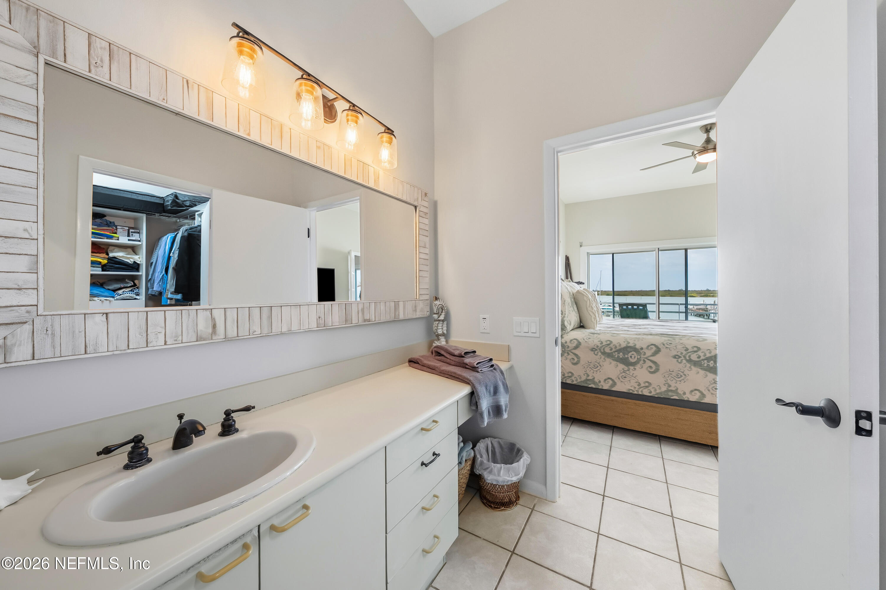 75 Comares Avenue, Unit 3A St. Augustine, FL 32080 - Photo 23 of 41 a en suite bathroom with a double vanity sink and a mirror