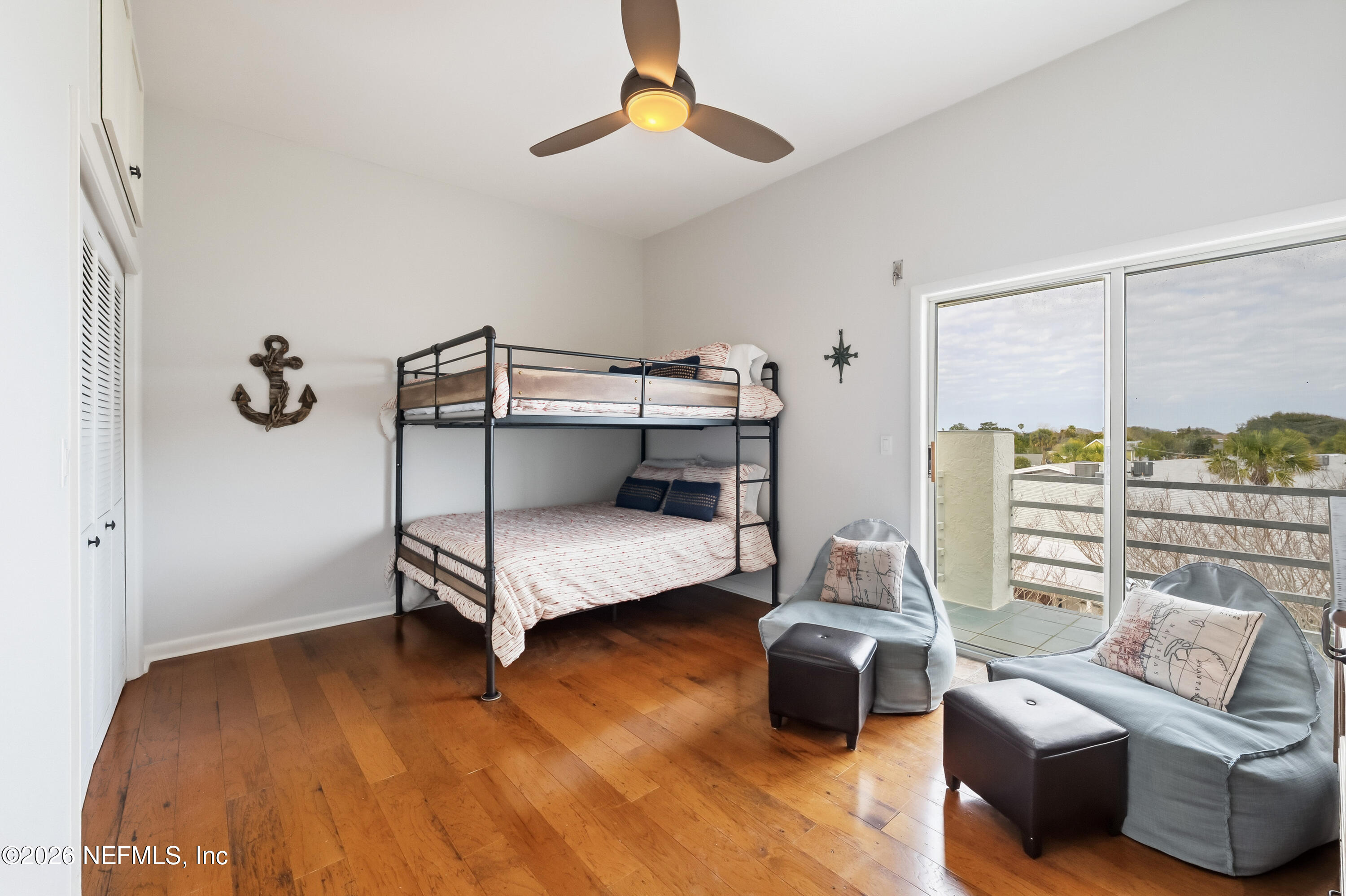 75 Comares Avenue, Unit 3A St. Augustine, FL 32080 - Photo 24 of 41 a bedroom with furniture and a chandelier