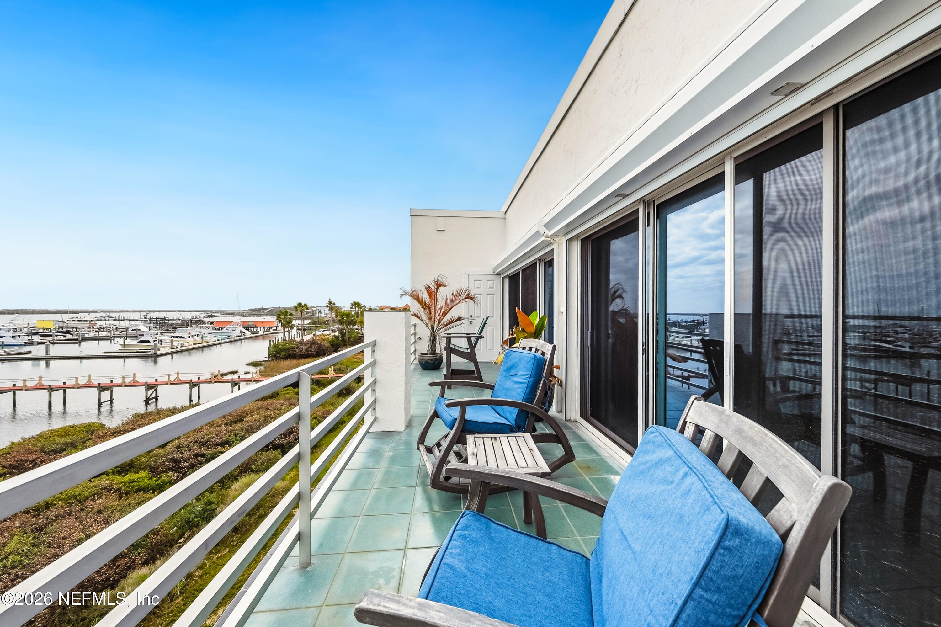 75 Comares Avenue, Unit 3A St. Augustine, FL 32080 - Photo 28 of 41 a view of balcony with chairs and wooden floor