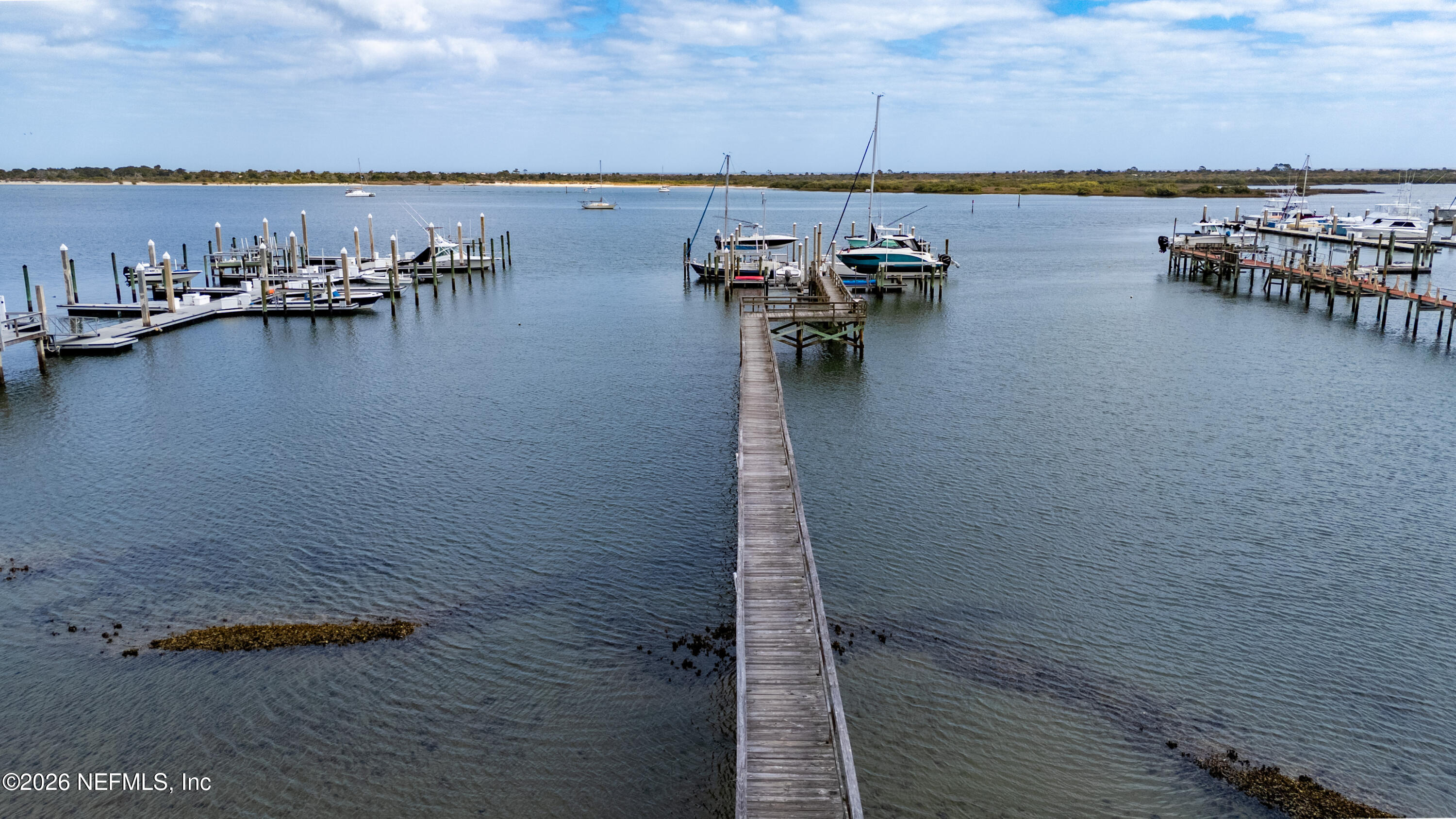 75 Comares Avenue, Unit 3A St. Augustine, FL 32080 - Photo 39 of 41 a view of a ocean with boats and trees in the back