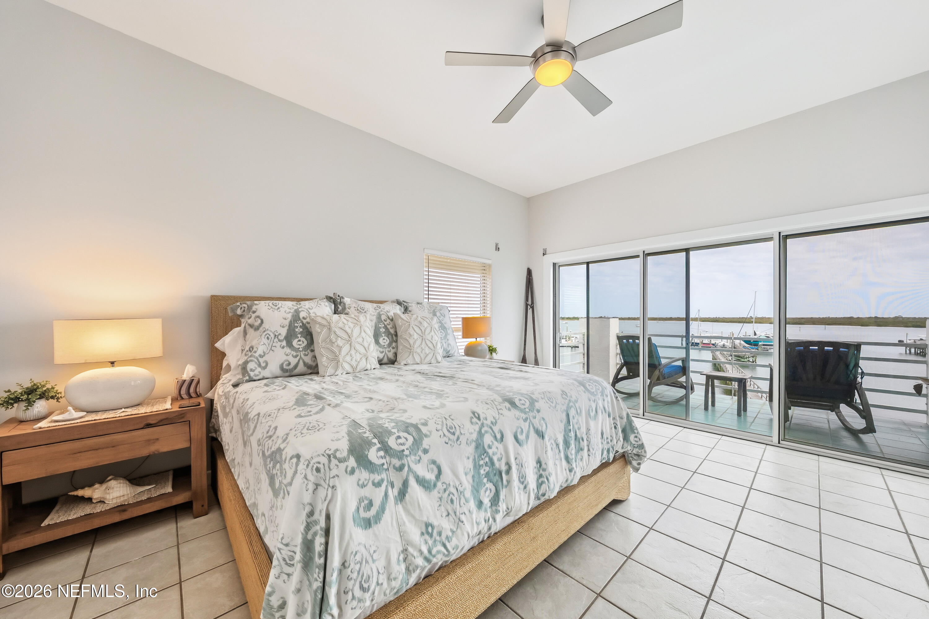 75 Comares Avenue, Unit 3A St. Augustine, FL 32080 - Photo 4 of 41 a bedroom with a bed and a chandelier
