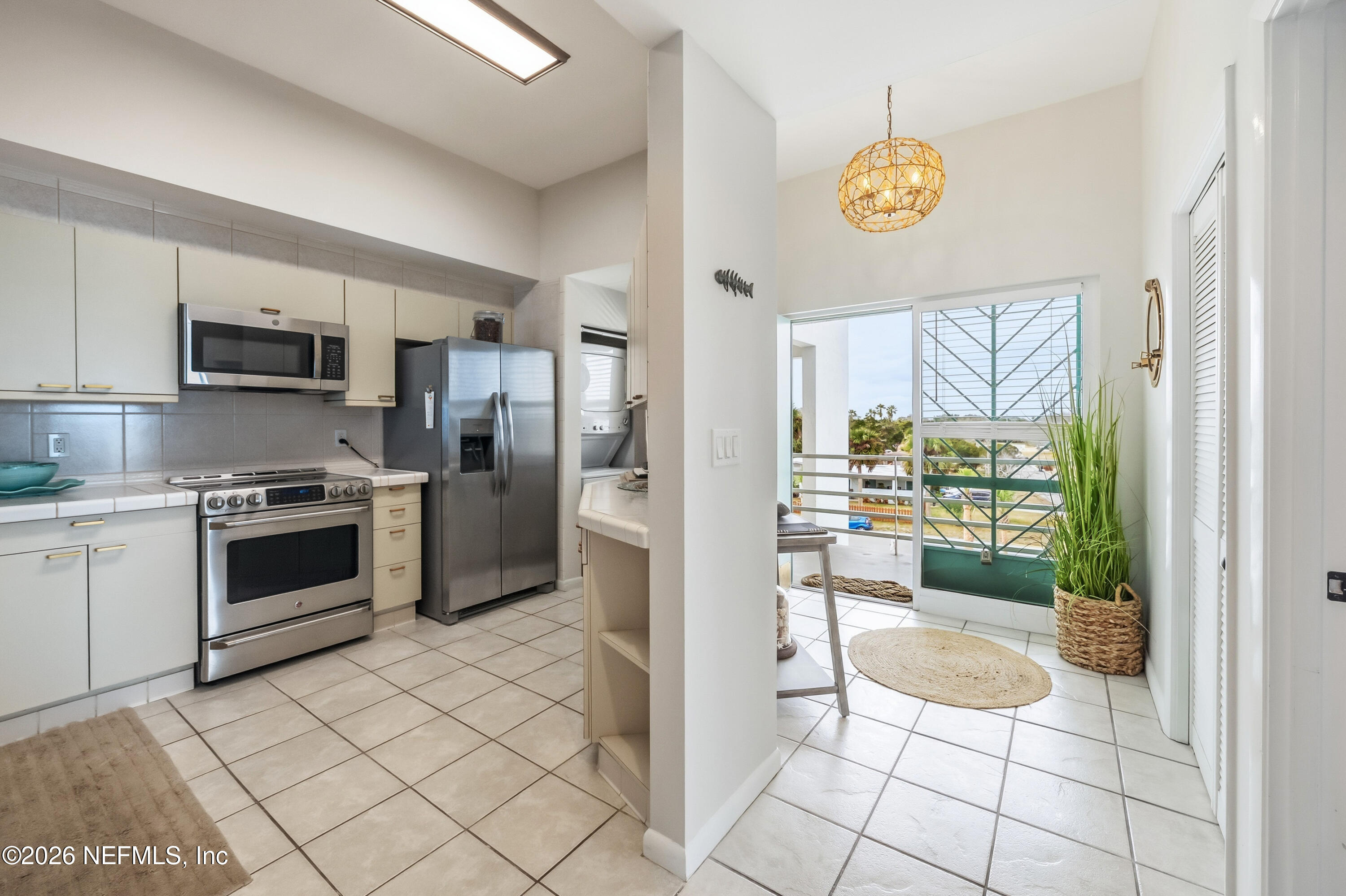 75 Comares Avenue, Unit 3A St. Augustine, FL 32080 - Photo 9 of 41 a kitchen with stainless steel appliances granite countertop a stove a sink and a refrigerator